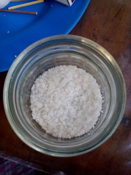 Salt has been added to the glass jar.