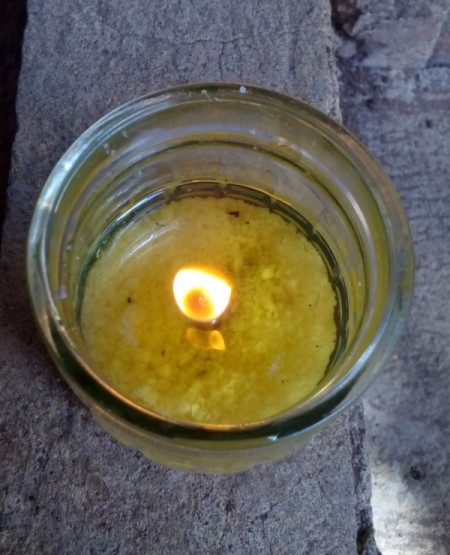 Burning wick inside the jar.