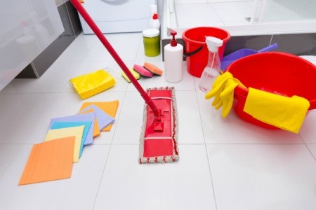 Floor cleaning tools like mop, rags, etc. displayed on vinyl tile floor
