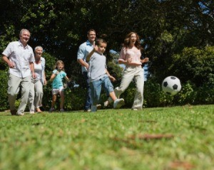 Multi-generational family playing soccer