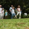 Multi-generational family playing soccer