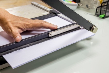 Close of up of a paper cutter being used to cut paper