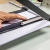 Close of up of a paper cutter being used to cut paper