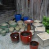 Bird Bath and several sizes of planters marked for sale.