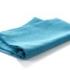 Folded blue cloth napkin on white background