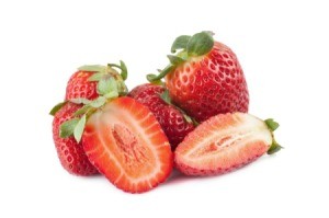 Whole and sliced strawberries isolated on white.