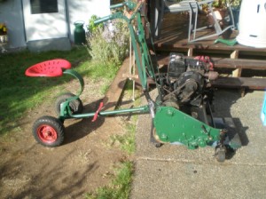 old mower with a tractor type ride behind seat