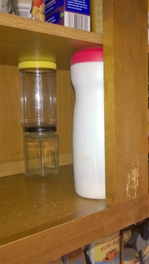 empty jars used to support a temporary cupboard shelf