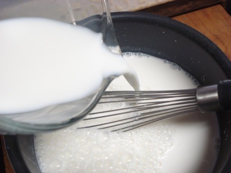 Adding milk to pan and wishing.