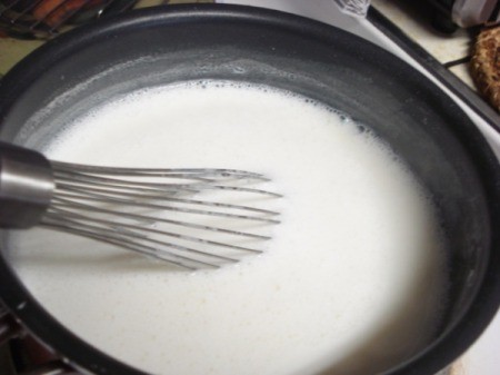 Continuing to wisk the ingredients in the pan.