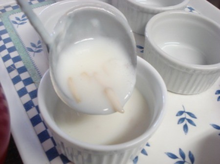 Ladeling pudding mixture into small serving dishes.