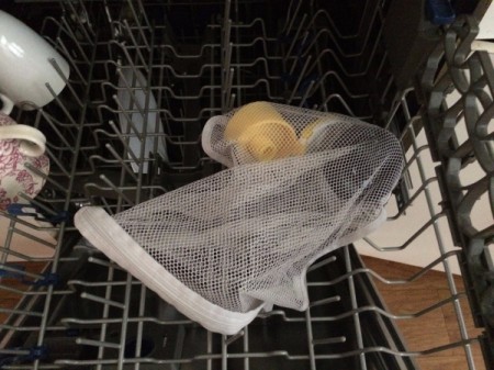 mesh bag with small items on top dishwasher rack