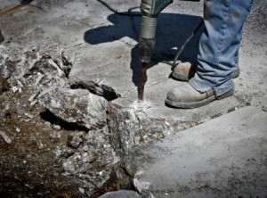 Man removing concrete with a jackhammer