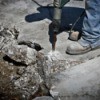 Man removing concrete with a jackhammer