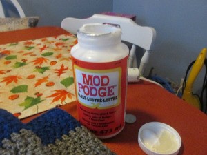 A bottle of Mod Podge for sealing knots and frays on a crochet project.
