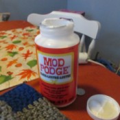 A bottle of Mod Podge for sealing knots and frays on a crochet project.