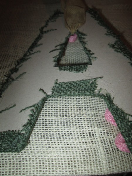 A cutout of the letter "A"with green fabric glued to it.