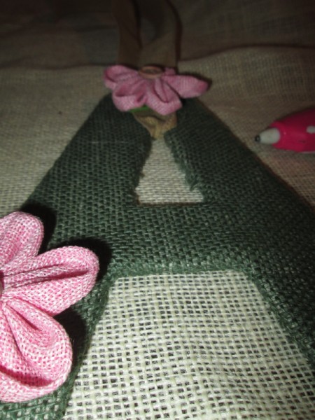 The green fabric covered "A" with pink flowers.