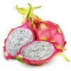 Dragon fruit against white background.  One whole, one is cut in half