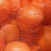 Close-up of oranges in an orange net bag