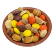 Snack mix of orange, brown, and yellow candies, butterscotch chips, pretzel nuggets, and nuts