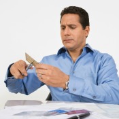 Man cutting up credit cards