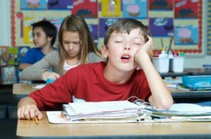 A 11 year old boy, asleep in class.