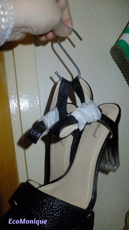 A pair of shoes hanging on a chain.