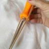 A rubber band over a screwdriver.