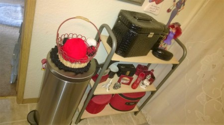 A shelf in the bathroom holding supplies.