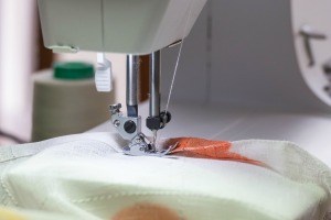 A sewing machine with material for a comforter.