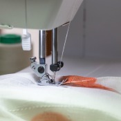 A sewing machine with material for a comforter.