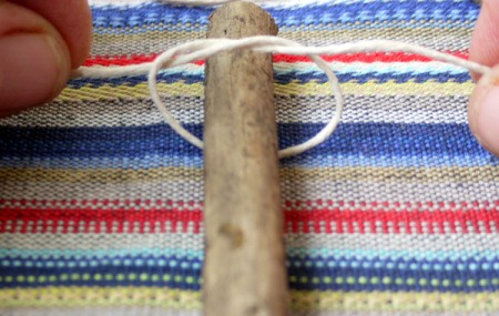 loop of string around first twig