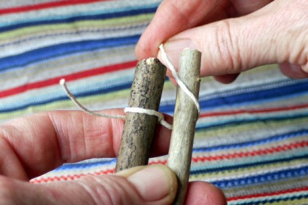 wrapping string around second twig from the back