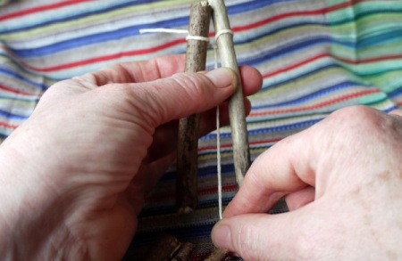 pulling string down between the twigs