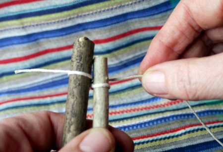 string now back around on the back side of second twig