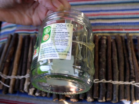 jar lying on top of twigs, ready to wrap them around