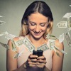 A woman with money flying out of her smartphone.