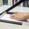 A paper cutter being used.