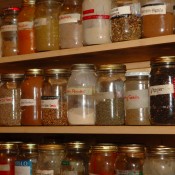 A fully stocked pantry lined with half full jars.