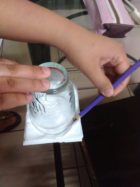 drawing a circle on stack of paper