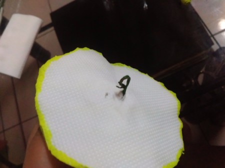 closeup of twist in wire on top of paper circle