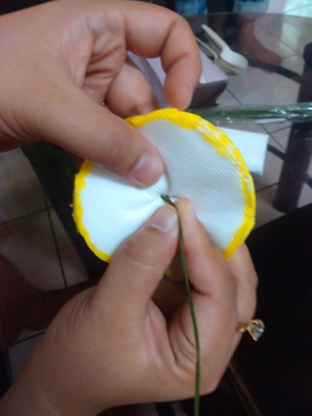 pushing wire through the center of the circles