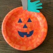 A Jack-o'-Lantern made from a paper plate.