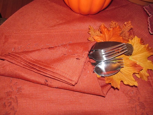 Festive flatware wrapped in a napkin.