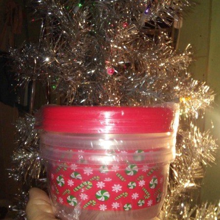 A container decorated with Christmas gift wrap.