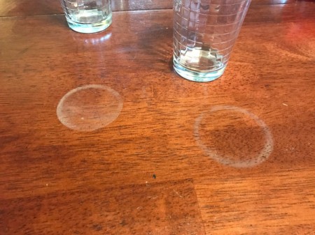 White rings left by drinks on a wood table.