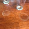 White rings left by drinks on a wood table.