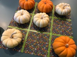 Tic Tac Toe game board and mini pumpkins for the Xs and Os