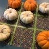 Tic Tac Toe game board and mini pumpkins for the Xs and Os